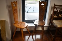 A pair of traditional spinning chairs, in different stains