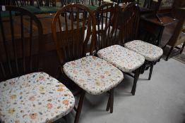 A set of four dark stained hoop and stick back kitchen chairs (probably Ercol)