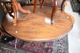 A Victorian mahogany loo table, having oval top on turned column and quadruple scroll legs,