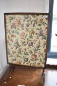 A vintage folding firescreen table with floral fabric insert