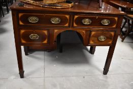 An Edwardian mahogany kneehole desk or dressing table, label to drawer for Wm Richardson, Leeds &