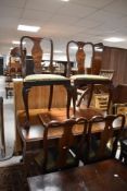 An early to mid 20th Century walnut extending dining table, four chair and a similar side cabinet,
