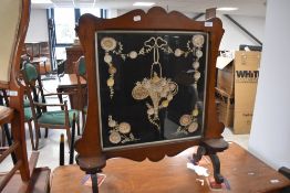 A Victorian mahogany firescreen having embroidered three dimensional panel