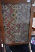 An Edwardian mahogany fire screen having tapestry inset