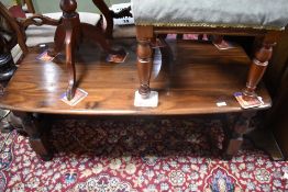 A dark stained coffee table on chunky legs, approx. 119 x 58cm