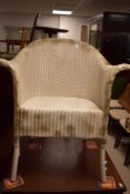 A vintage woven-wicker armchair, in the Lloyd Loom style, white painted with gold painted highlight