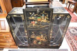 A vintage ebonised side by side bureau display having ebonised finish with typical chinoiserie