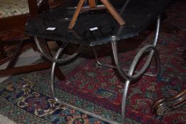 A vintage coffee table having chrome frame and black glass board top