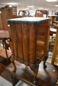 An early to mid 20th Century bedside cabinet on cabriole legs