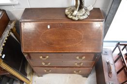 An Edwardian mahogany bureau in the George III style, width approx. 75cm