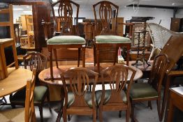 A reproduction Regency mahogany dining table and six (four plus two) similar chairs