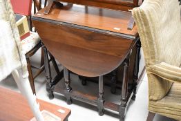 An early 20th Century mahogany gateleg dining table, width approx. 73cm