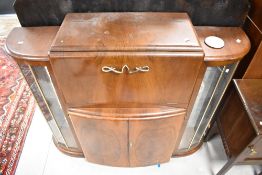 A mid 20th Century walnut cocktail cabinet