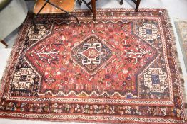 A persian style rug having red ground, approx. 205 x 157cm