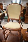 A Victorian mahogany rocking chair with later upholstery
