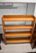 A vintage light stained open bookshelf, approx width 76cm