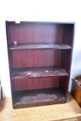 A modern mahogany effect low bookshelf, width approx. 62cm