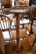 A reproduction turned jardiniere stand/torchere