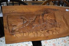 A carved treen panel depicting work horses hauling timber