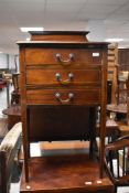 An Edwardian mahogany three drawer music cabinet