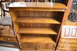 A Cryer Craft Elm bookcase, with cupboard base, dimensions approx. W110 H144 D32cm