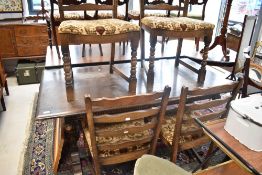 A priory style dark oak refectory table and four similar ladder back chairs
