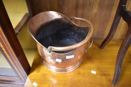 A traditional copper coal helmet having hammered finish