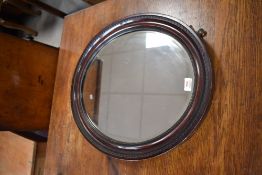 An early 20th century grained wood and bevelled glass wall mirror 60cm