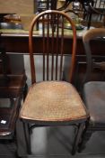 An interesting Thonet bentwood bistro chair, with arched and slatted back over the moulded crocodile