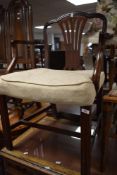 A reproduction mahogany armchair, of Georgian design with pierced central splat, shaped arms and