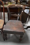 A Victorian Mahogany James Reilly pegged balloon back dining chair, with carved mid-rail over the