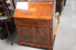 A reproduction inlaid mahogany bureau, of traditional design, the fall-front with inlaid sunburst