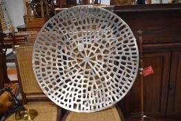 A large decorative pierced metal wall art panel, of dished circular form, 60cm diameter