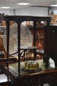 An Edwardian design mahogany occasional table, of oval form with fluted and foliate carved