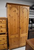 A modern pine double door wardrobe, with fielded panels 190cm