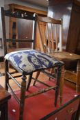 An early 20th century spindle back kitchen chair, sold along with an Edwardian bedroom chair