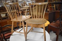 A vintage spindle back kitchen chair in the Ercol style, and similar carver chair (af)