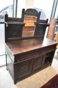 An 18th century and later oak dressing table, adapted from old carved timbers 132cm x 115cm