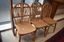 A group of three vintage wheel back chairs, of traditional form