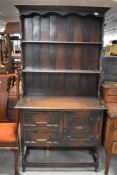An early-mid 20th 20th century oak dresser and rack, of traditional design with geometric moulded