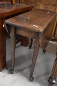 A 19th century mahogany drop leaf table, of traditional design with demi-lune flaps and turned