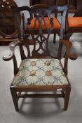 A reproduction mahogany child's chair, of George III design with yoke-form top rail and pierced