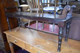 A late Victorian mahogany window seat, with scrolled and turned 'handles' to each end 135cm long