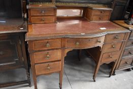 An Edwardian mahogany ladies writing desk, with central bow-front, and an arrangement of drawers,
