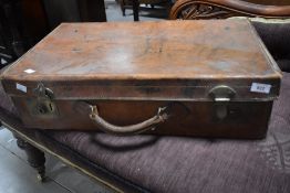 A vintage stitched leather suitcase, of traditional design with brass locks 60cm the top rear left
