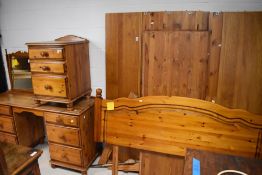 A group of modern pine bedroom furniture, comprising dressing table, bedside chest, double bedhead
