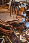 A reproduction oak nest of three tables, with tooled leather surface, sold together with a
