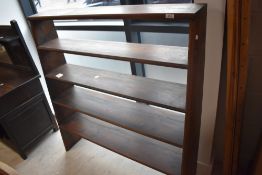A freestanding stained pine graduating bookshelf with four tiers 121cm x 114cm