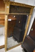 A 19th century regency period gilt wood pier glass, having an inverted break-front surmount with