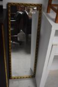 A modern gilt frame wall mirror, approx. 96 x 34cm